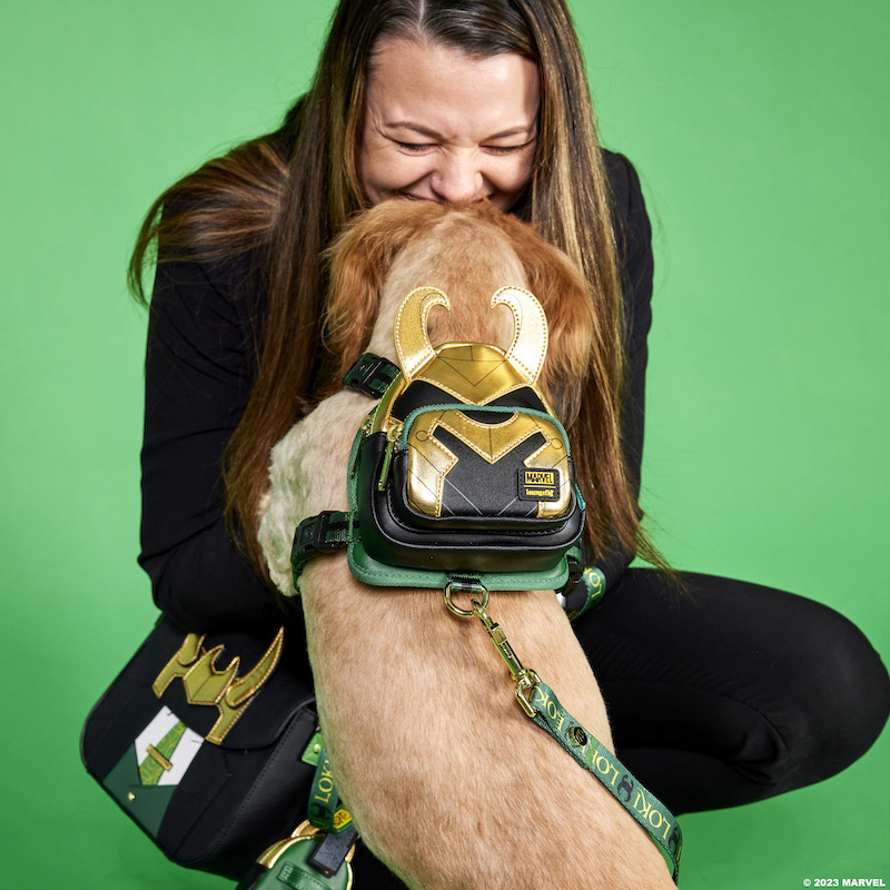 Image of woman with dog wearing the Loki Mini Backpack Harness and leash against a green background